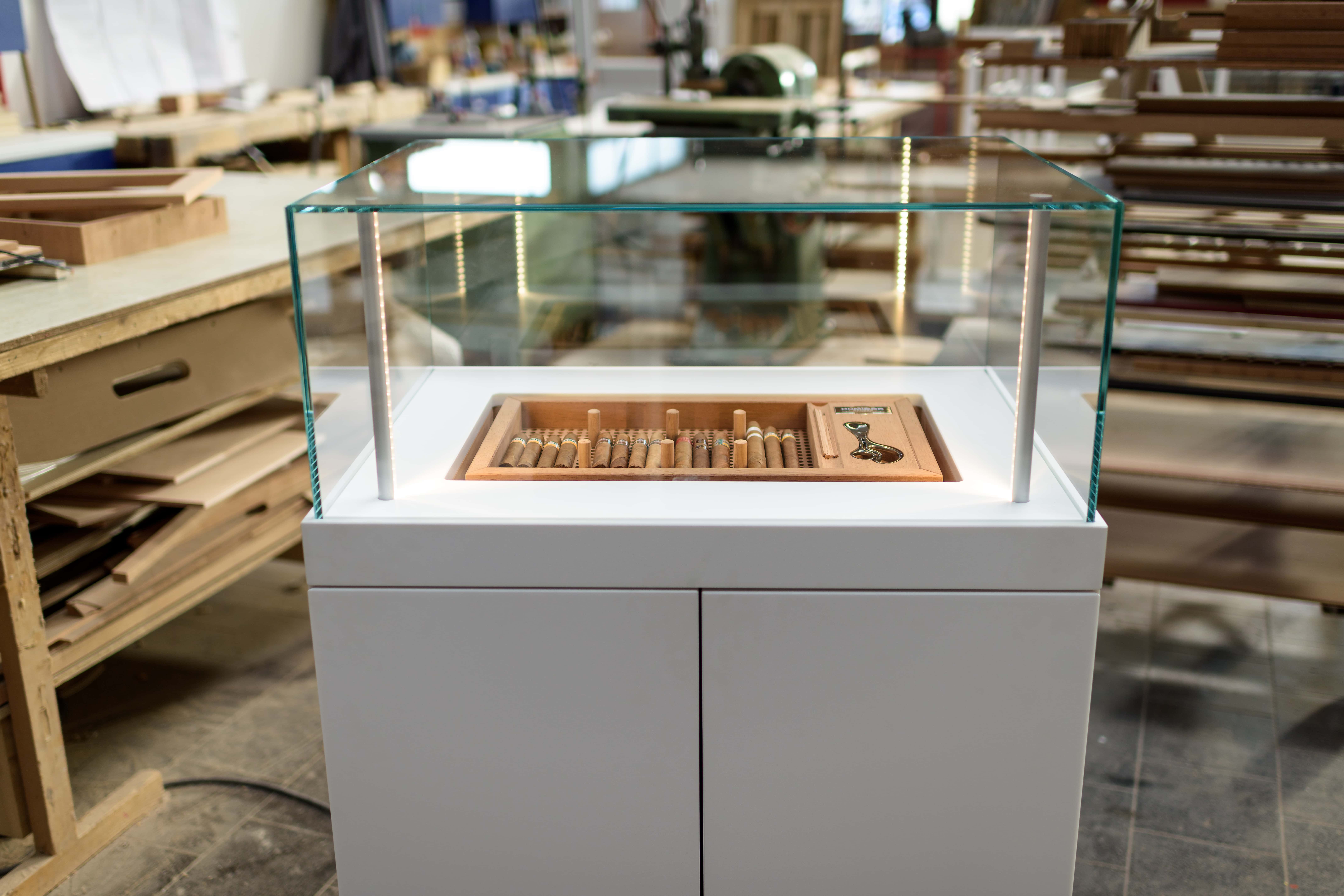 The glass dome of the cigar cabinet lifts at the touch of a button on the remote control.